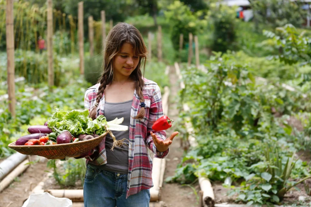 photo of woman examining pepper on a farm