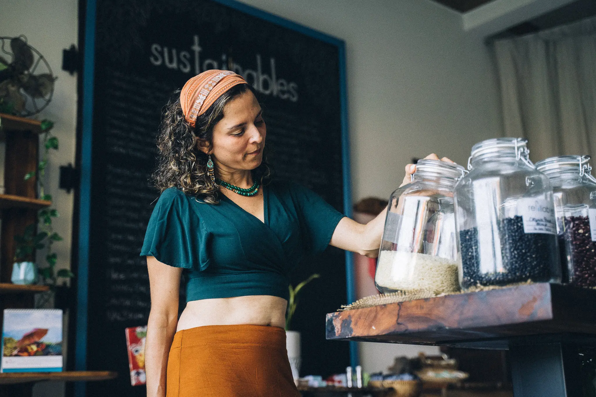 woman looking at a jar in a cafe