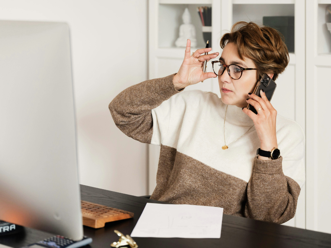 Customer on the phone in front of their laptop