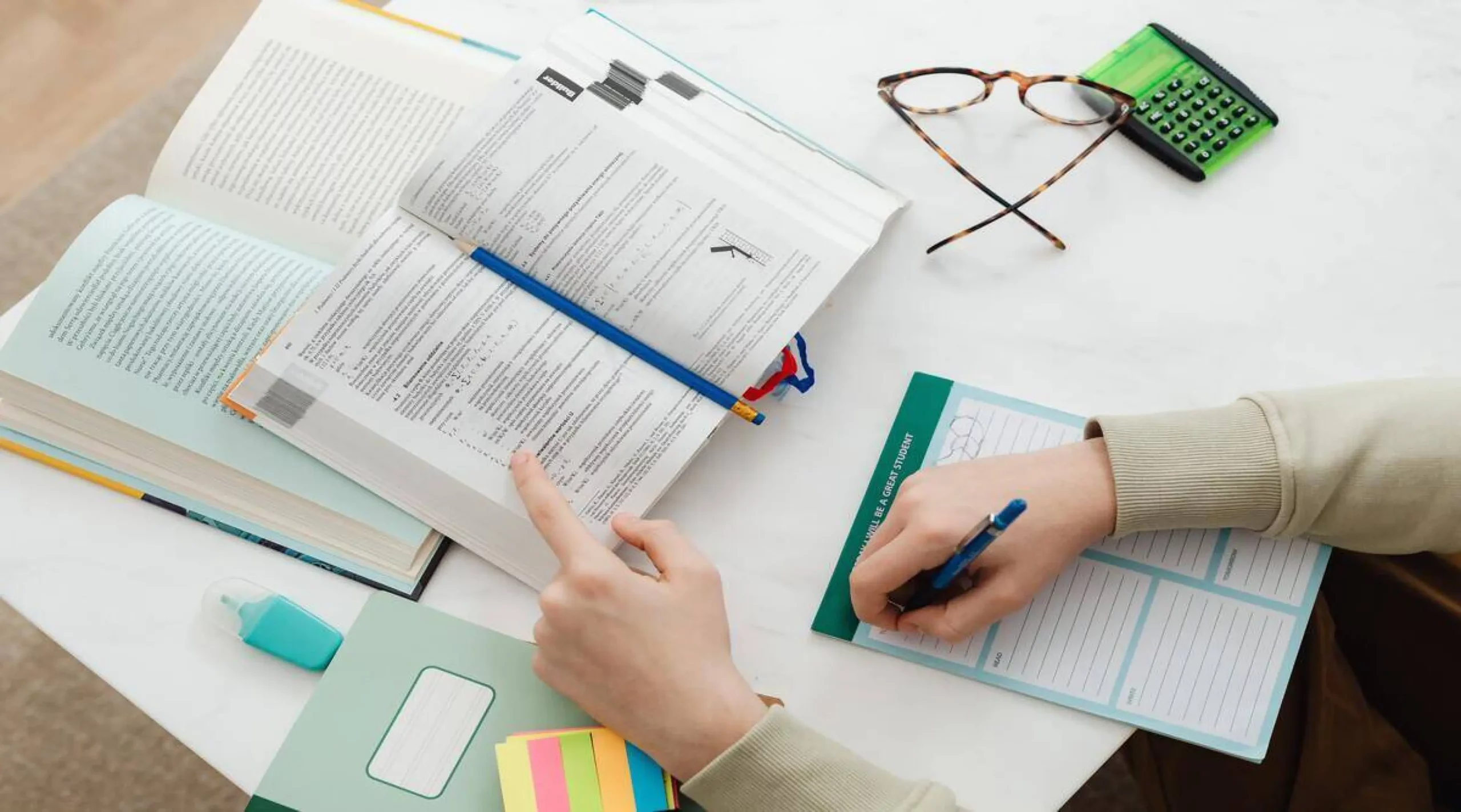image of someone working on documents on a table